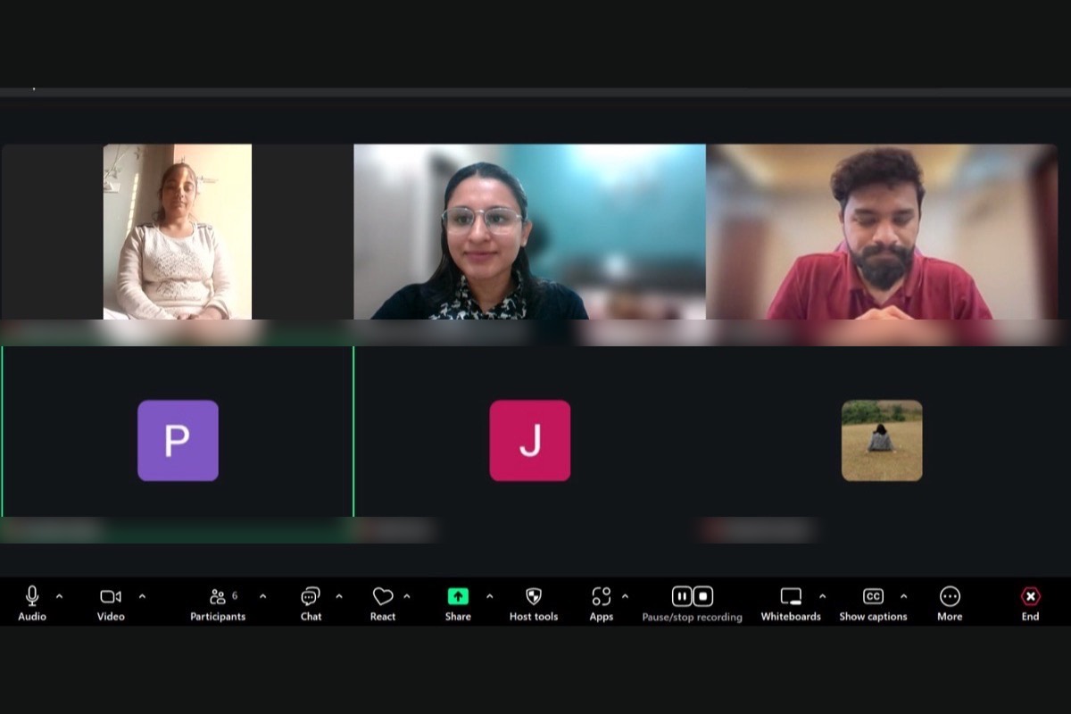 Participants in an online session sitting with their eyes closed during a guided grounding practice